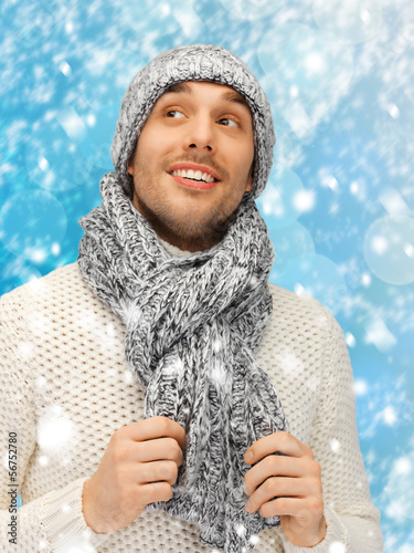 Photo: handsome man in warm sweater, hat and scarf handsome man in warm sweater, hat and scarf