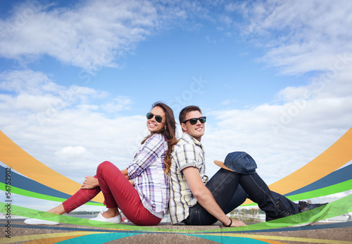 Photo: teenagers sitting back to back teenagers sitting back to back