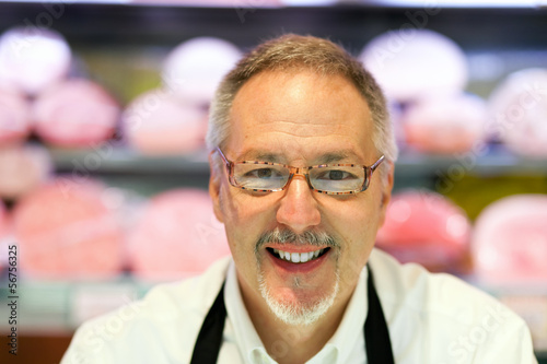 Photo: Smiling shopkeeper in a butcher shop Smiling shopkeeper in a butcher shop