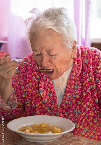 Photo: Senior woman eating soup Senior woman eating soup
