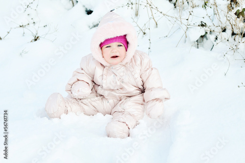 Photo: baby sitting in snowdrift baby sitting in snowdrift