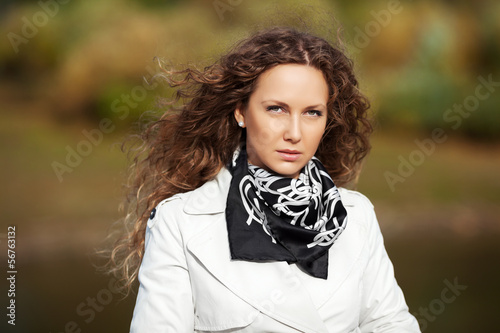 Photo: Beautiful woman in white against autumn nature background Beautiful woman in white against autumn nature background
