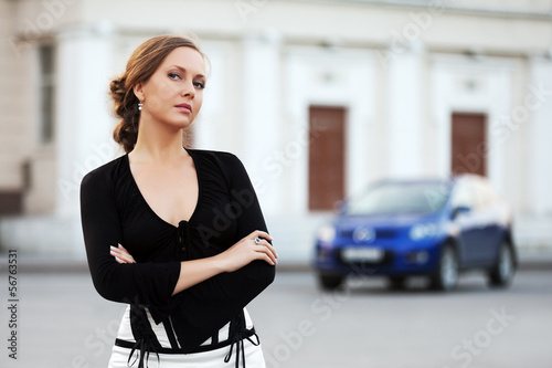 Photo: Beautiful woman walking on the city street Beautiful woman walking on the city street