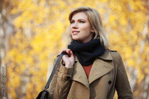 Photo: Happy blond woman in autumn forest Happy blond woman in autumn forest