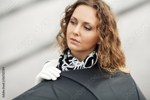 Photo: Sad beautiful woman with umbrella Sad beautiful woman with umbrella