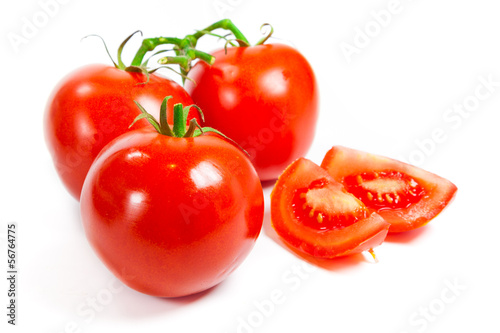 Photo: Closeup of tomatoes on the vine isolated on white. Tomato branch Closeup of tomatoes on the vine isolated on white. Tomato branch