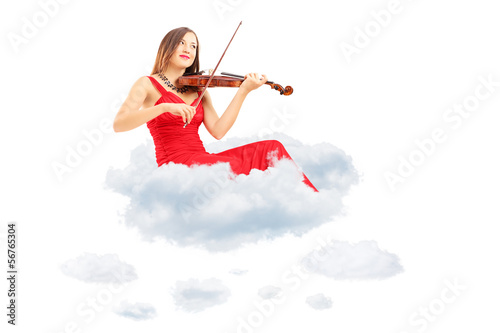 Photo: Young woman in red dress playing the violin seated on clouds Young woman in red dress playing the violin seated on clouds