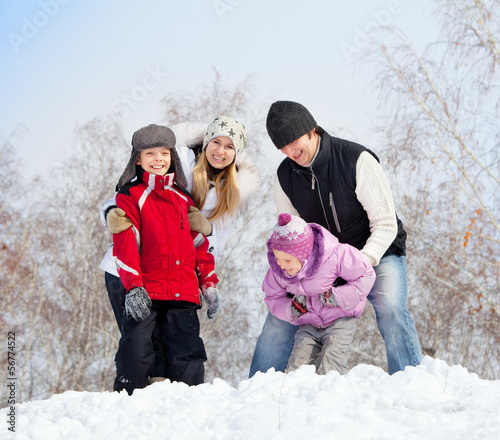 Photo: Happy family in winter park Happy family in winter park