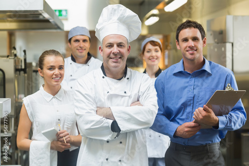 Photo: Head chef posing with the team behind him Head chef posing with the team behind him