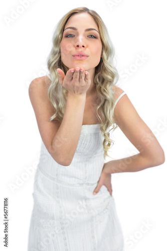 Photo: Cheerful blonde sending a kiss to camera Cheerful blonde sending a kiss to camera