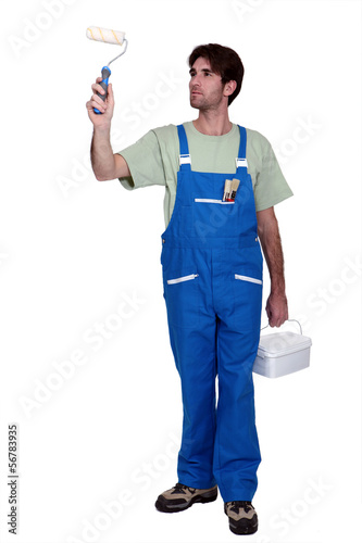 Photo: Decorator with paint and a roller Decorator with paint and a roller