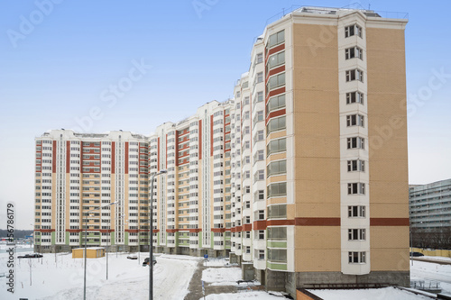 Photo: Large new residential apartment building of colored bricks Large new residential apartment building of colored bricks