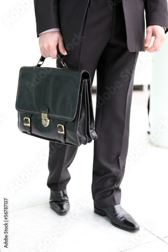 Photo: Businessman holding a briefcase Businessman holding a briefcase