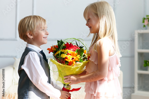 Photo: Boy is presented flowers to girl Boy is presented flowers to girl