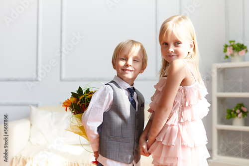 Photo: Boy is presented flowers to girl Boy is presented flowers to girl
