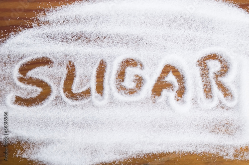 Photo: The word sugar written into a pile of white granulated sugar The word sugar written into a pile of white granulated sugar