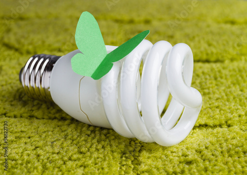 Photo: Energy saving bulb on a green background Energy saving bulb on a green background