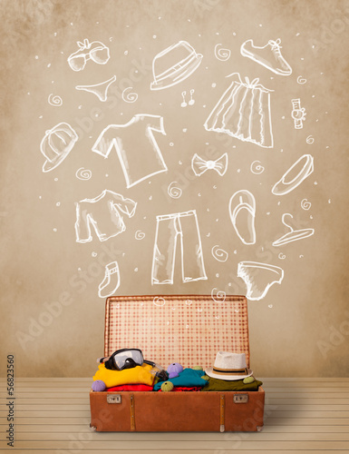 Photo: Traveler luggage with hand drawn clothes and icons Traveler luggage with hand drawn clothes and icons