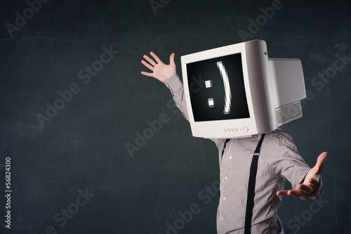 Photo: Funny young businessman with a monitor on his head and smiley on Funny young businessman with a monitor on his head and smiley on