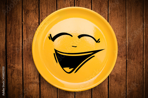 Photo: Happy smiley cartoon face on colorful dish plate Happy smiley cartoon face on colorful dish plate