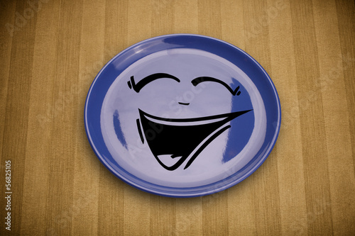 Photo: Happy smiley cartoon face on colorful dish plate Happy smiley cartoon face on colorful dish plate