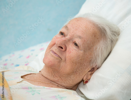 Photo: Old sick woman lying at bed Old sick woman lying at bed