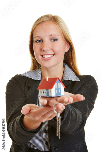 Photo: Woman with house and keys on hand Woman with house and keys on hand
