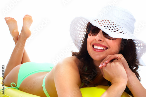 Photo: Woman wearing sunglasses and a hat. Woman wearing sunglasses and a hat.