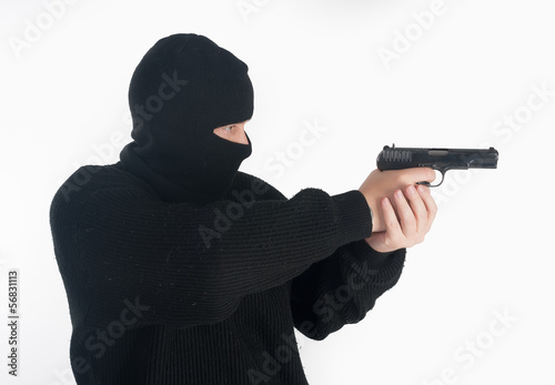 Photo: masked man aims with gun masked man aims with gun