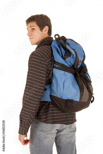 Photo: Casual dressed young man with blue backpack looking over shoulde Casual dressed young man with blue backpack looking over shoulde