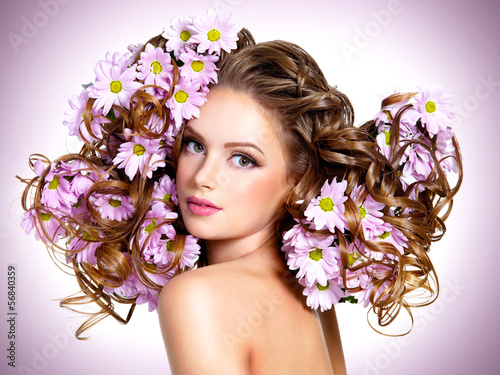 Photo: Young beautiful woman with flowers in hairs Young beautiful woman with flowers in hairs