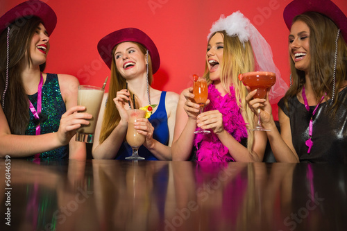Photo: Laughing friends at a hen night drinking cocktails Laughing friends at a hen night drinking cocktails
