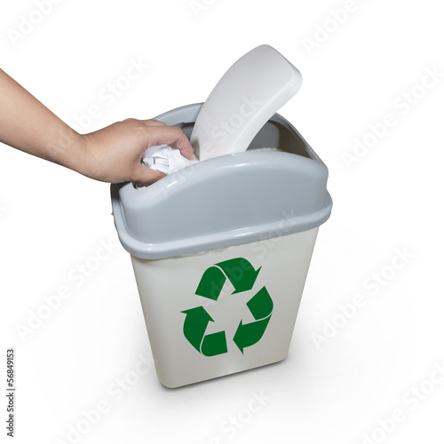 Photo: hand putting a paper garbage into recycling bin hand putting a paper garbage into recycling bin