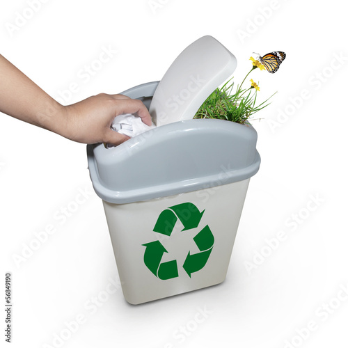 Photo: hand putting a paper garbage into recycling bin hand putting a paper garbage into recycling bin
