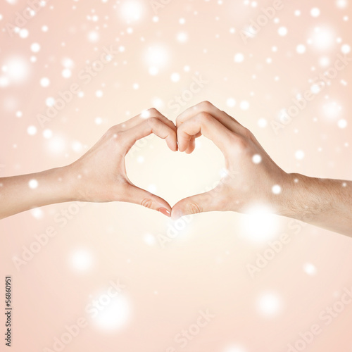Photo: woman and man hands showing heart shape woman and man hands showing heart shape