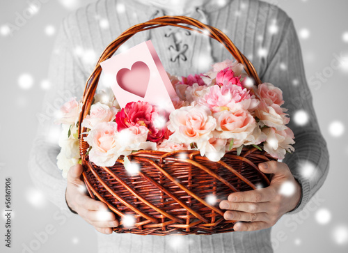 Photo: man holding basket full of flowers and postcard man holding basket full of flowers and postcard