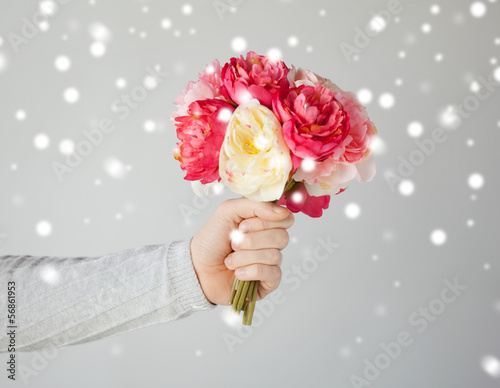 Photo: man holding bouquet of flowers man holding bouquet of flowers