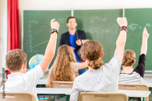 Photo: Teacher educate or teaching a class of pupils in school Teacher educate or teaching a class of pupils in school