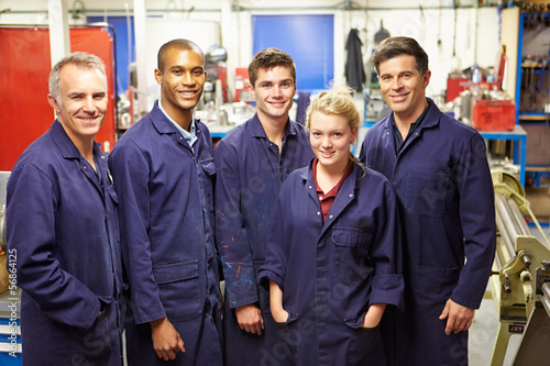 Photo: Portrait Of Staff Standing In Engineering Factory Portrait Of Staff Standing In Engineering Factory