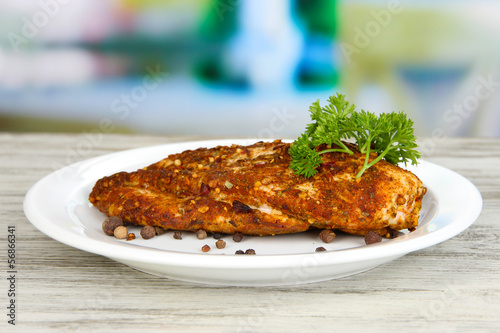 Photo: Roasted chicken fillets on white plate on bright background Roasted chicken fillets on white plate on bright background