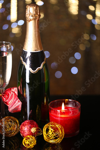 Photo: Bottle of champagne with glass and Christmas balls Bottle of champagne with glass and Christmas balls