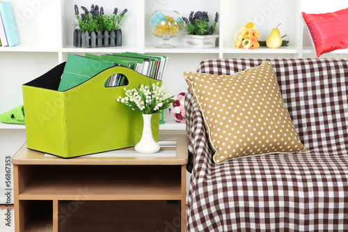 Photo: Magazines and folders in green box on bedside table in room Magazines and folders in green box on bedside table in room