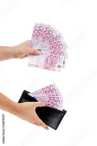 Photo: Five hundred euro notes in hand and purse. Five hundred euro notes in hand and purse.