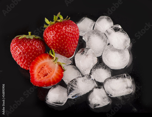 Photo: ice cubes, mint leaf, fresh strawberry on black ice cubes, mint leaf, fresh strawberry on black