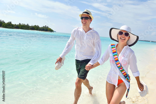 Photo: happy young couple have fun on beach happy young couple have fun on beach