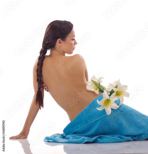 Photo: beautiful woman with blue spa towels on white beautiful woman with blue spa towels on white