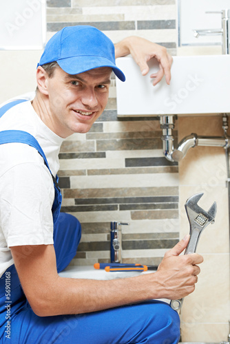 Photo: Young smiling plumber man worker Young smiling plumber man worker