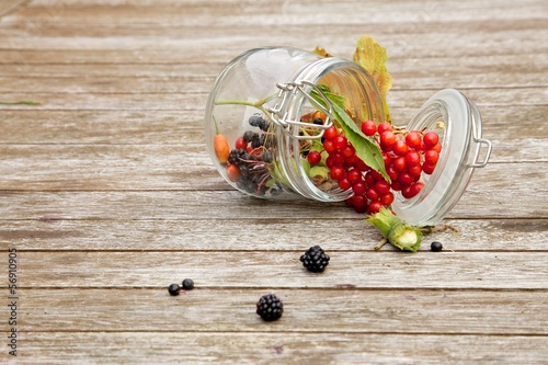 Photo: Fruits of the forest on woody background Fruits of the forest on woody background