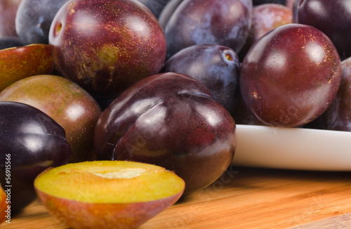 Photo: fresh plums on wooden table fresh plums on wooden table
