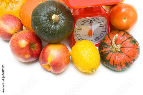 Photo: Vegetables, fruits and kitchen scales close-up. white background Vegetables, fruits and kitchen scales close-up. white background